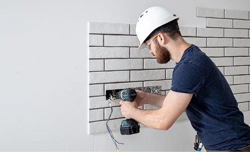 residential electrician in Ontario CA installing electrical sockets